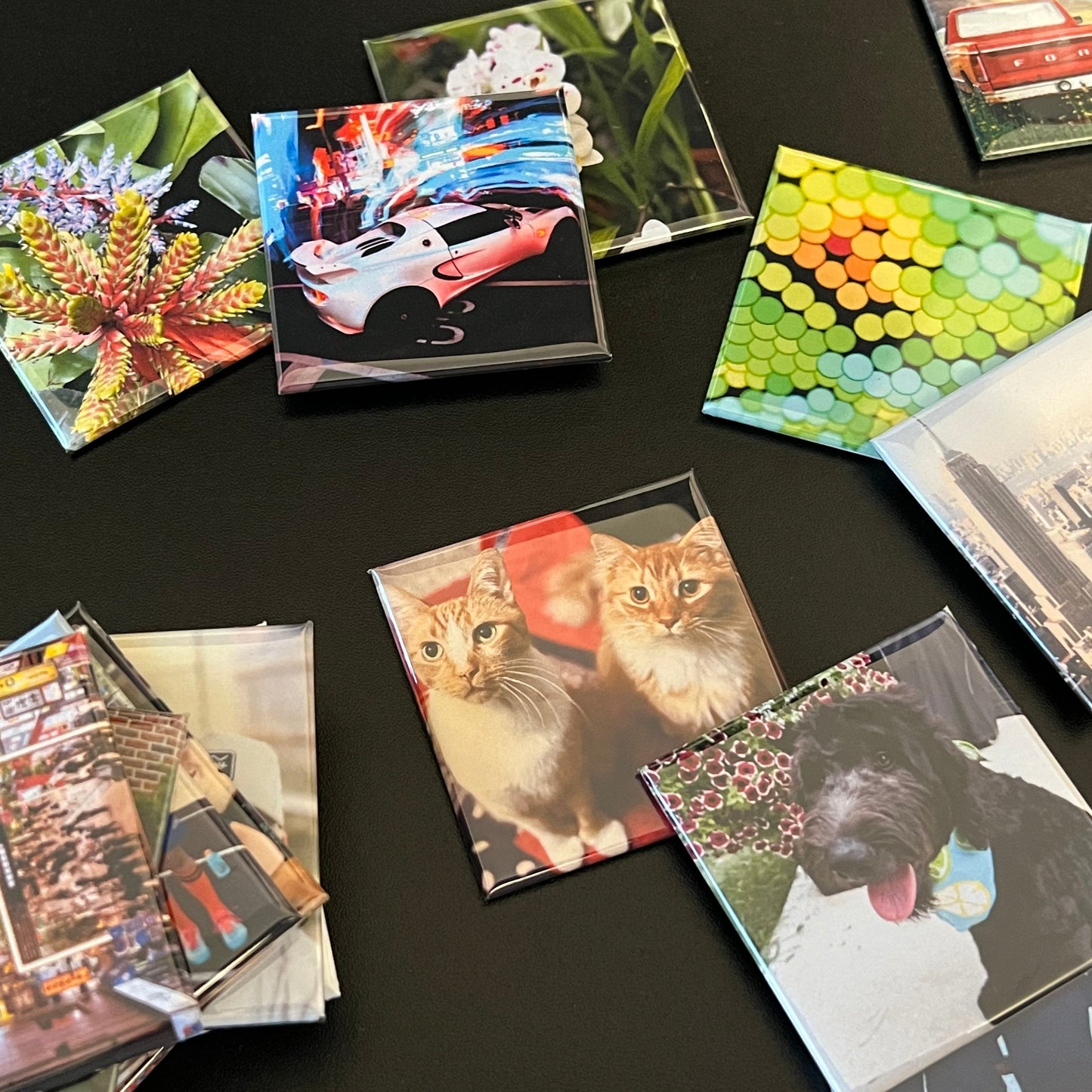 Collection of small photo albums with various images on a dark surface