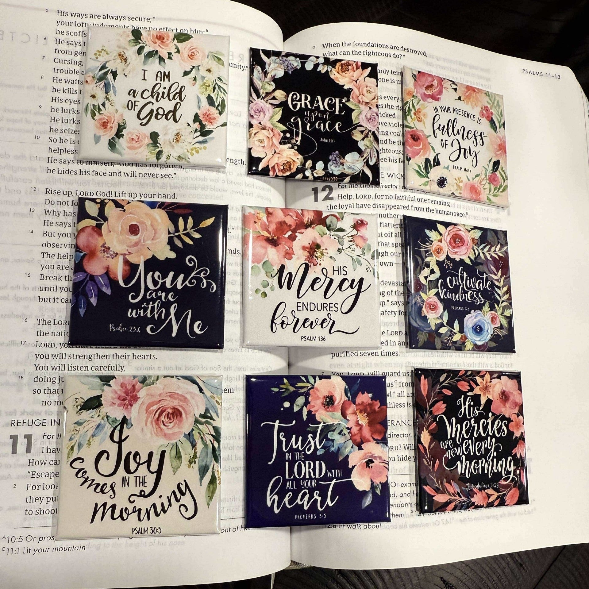 Open book with decorative stickers featuring motivational phrases and floral designs.