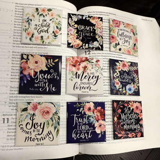 Open book with decorative stickers featuring motivational phrases and floral designs.